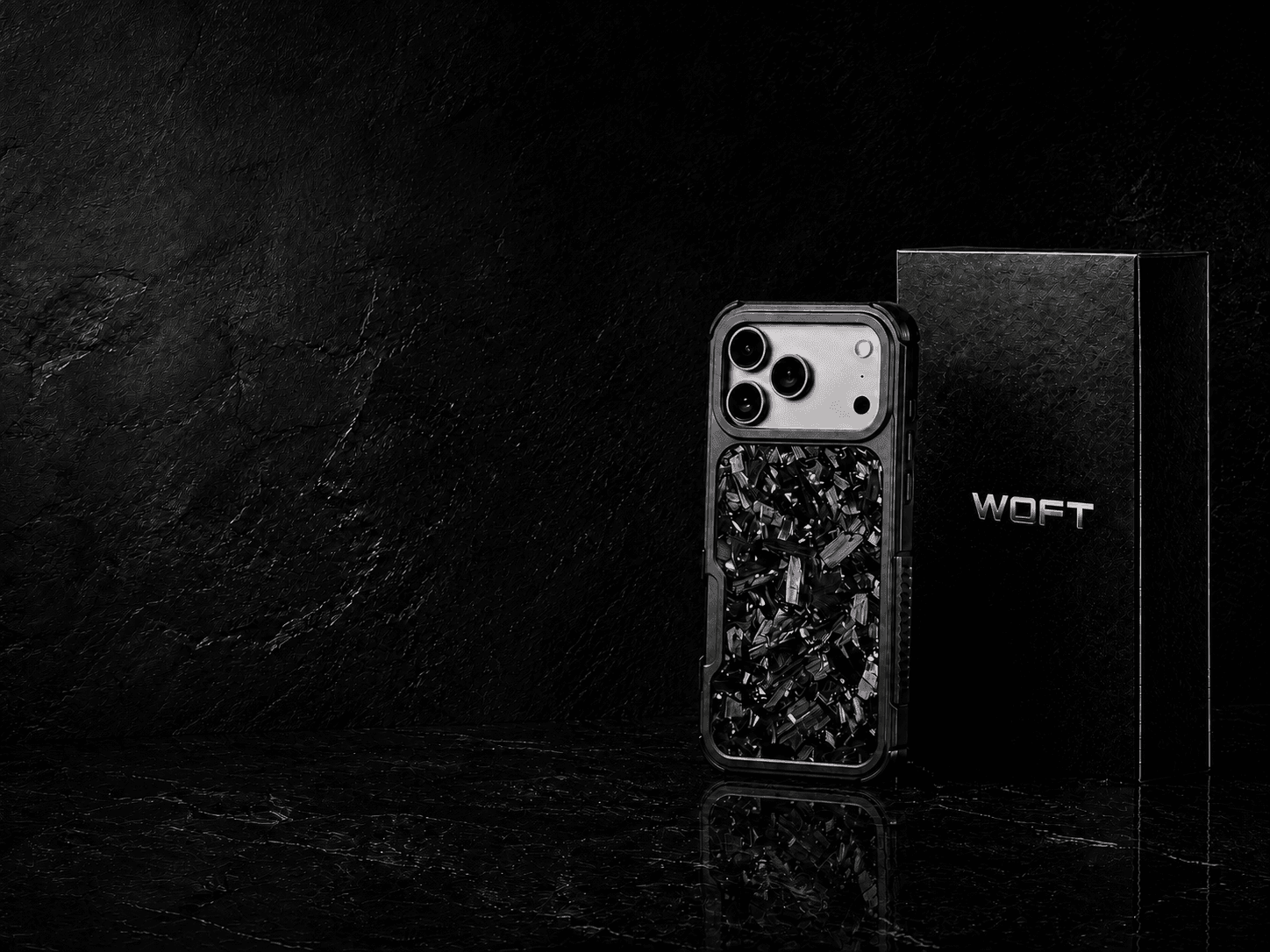 Phantom Violet forged carbon case with a silver iPhone and black WOFT packaging