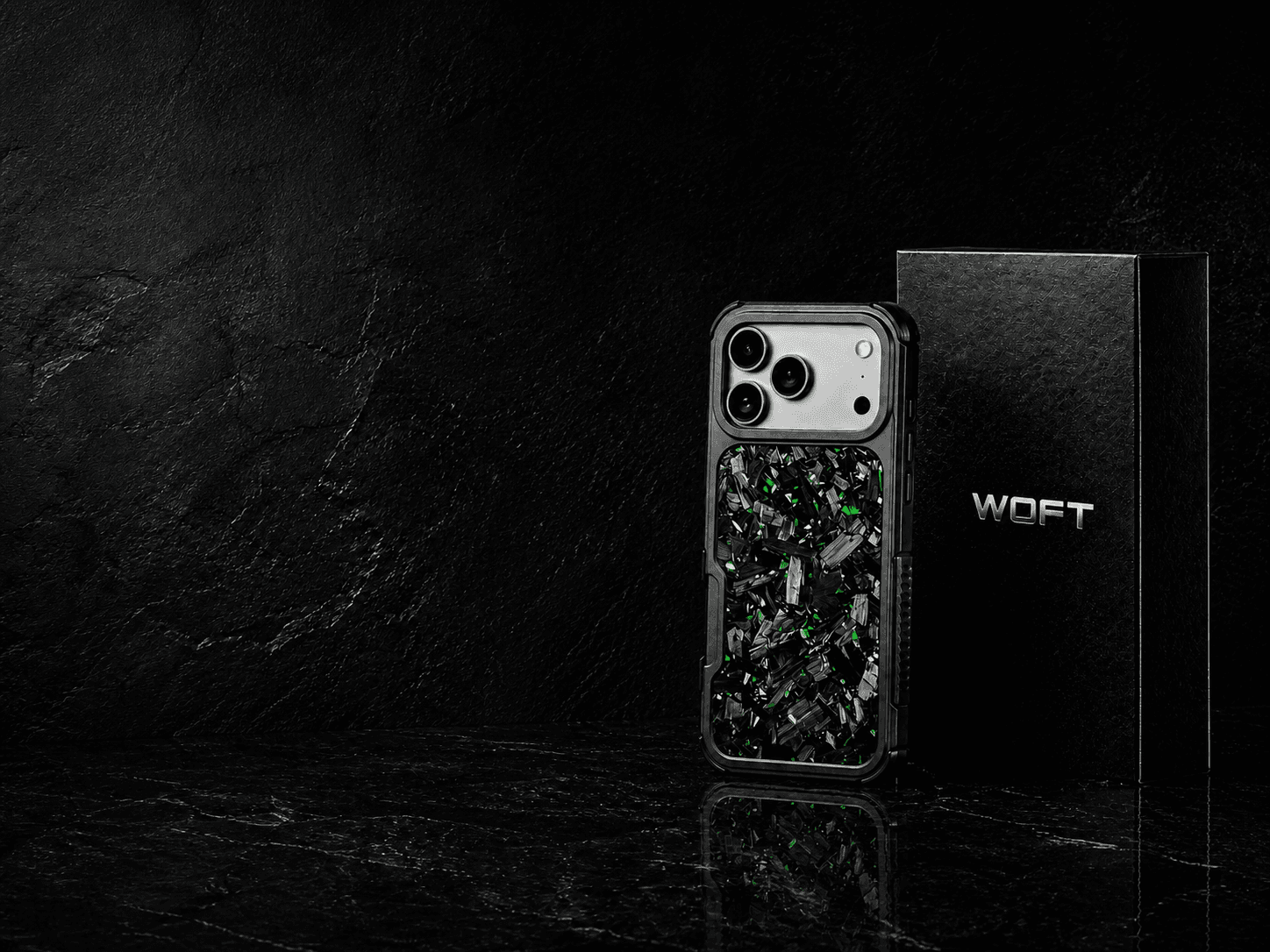Emerald Veil forged carbon case with a silver iPhone and black WOFT packaging